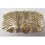 9ct yellow gold tapering 14 bar gate bracelet, with heart padlock clasp, stamped 375, 24.6g