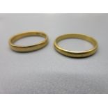 two 22ct yellow gold wedding bands, sizes L1/2 and M, both stamped 22, 5.2g