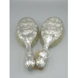 Pair of Edward VII Silver backed hairbrushes, rapusay decoration set with the three graces, Makers