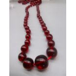 Set of graduated cherry red Bakelite beads, double knotted, 75.3g, largest W2cm