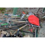 Large collection of garden tools, including spades, brushes, racks, hammers, sheers, hedge loppers