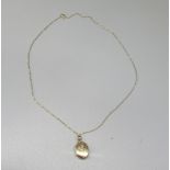 9ct yellow gold pendant locket with engraved detail, stamped 375, on 9ct yellow gold chain,