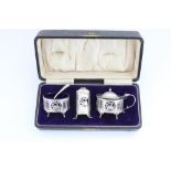 Hallmarked silver three piece cruet set, with Bristol blue glass liners in fitted case, the bodies