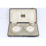 Pair of hallmarked silver small bowls in fitted case, lip decorated with repeating reticulated