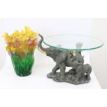 Modern table centre, clear glass bowl on elephant moulded base, and a Silea coloured flower