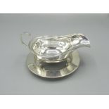 George V Silver sauce boat with C-scroll handle on three hoof feet makers by CW Fletcher & Son LTD