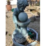 Fibre glass garden water feature in the form of a young boy over a water feature including pump