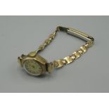 Ladies regency gold hand wound wrist watch with signed dial applied Arabic and Baton hour markers,