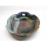 Large studio pottery glazed fruit bowl with flared rim, with polychrome slip glaze dripped