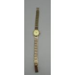 Ladies Accurist gold Quartz wrist watch on integrated gate style bracelet signed champagne dial with