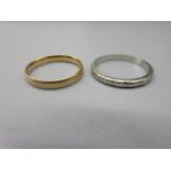 18ct yellow gold plain wedding band, size L1/2, and a 18ct white gold wedding band with etched