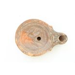 C1st CE Ancient Cypriot Roman terracotta oil lamp, central well decorated in relief with a hunter