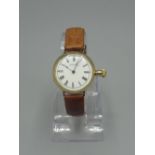 Waltham rolled gold hand wound wristwatch - formally fob watch. Signed white enamel dial with