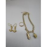 Yellow metal charm bracelet set with two 9ct yellow gold charms, and one yellow metal charm, gross