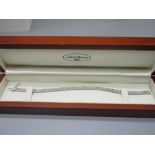 9ct white gold tennis bracelet set with diamonds in illusion settings, stamped 375, 19cm (