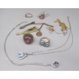 Hallmarked Sterling silver necklace with oval cut light blue stone surrounded by clear stones, and