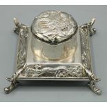 Early C20th Chinese silver square inkwell, hinged cover and tapering base relief decorated with