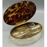George V hallmarked silver manicure set, oval with hinged tortoiseshell lid, fitted interior with