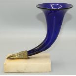 Regency style blue glass Cornucopia vase, with brass hand mount on rectangular white marble base,