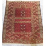 Caucasian red ground wool prayer rug, with geometric field in repeating geometric hooked striped