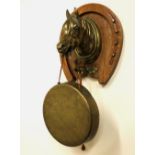 Edwardian oak and brass dinner gong, cast heavy horse mount on horseshoe shaped oak mount set with