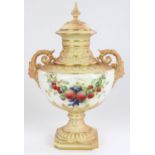 Royal Worcester twin handled pedestal urn and cover, with mask form scrolling handles and reeded