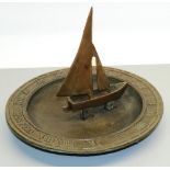 C20th patinated cast metal circular sundial, Roman numeral border with boat gnomon, D31cm H24cm