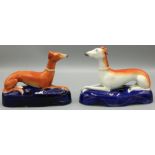 Two Victorian Staffordshire greyhound pen holders, on blue painted bases, W15cm H13cm (2)