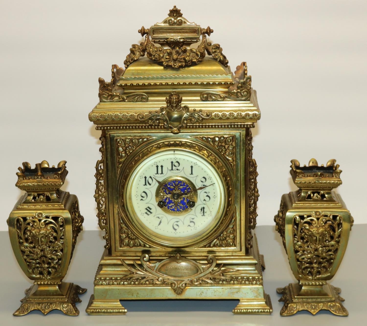 F. Marti, late 19th century brass presentation three-piece clock garniture, cream Arabic dial,