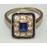 Art Deco white metal diamond and sapphire ring, the central baguette cut sapphire surrounded by