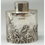 Victorian hallmarked silver tea caddy, oval body repousse decorated with Putti in a seascape, by