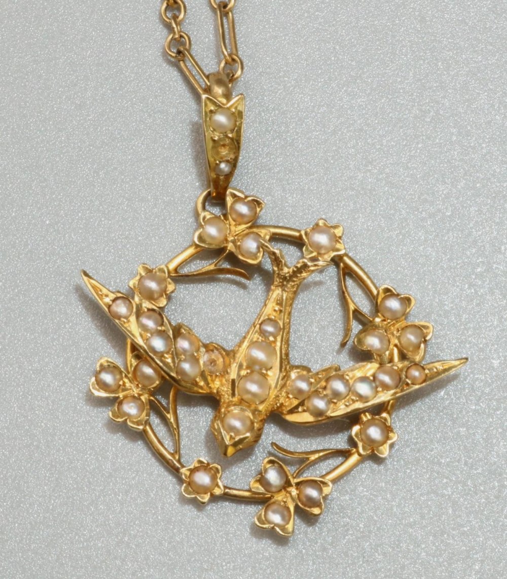 18ct yellow gold Edwardian swallow pendant set with seed pearls, stamped 18k with worn hallmarks, on