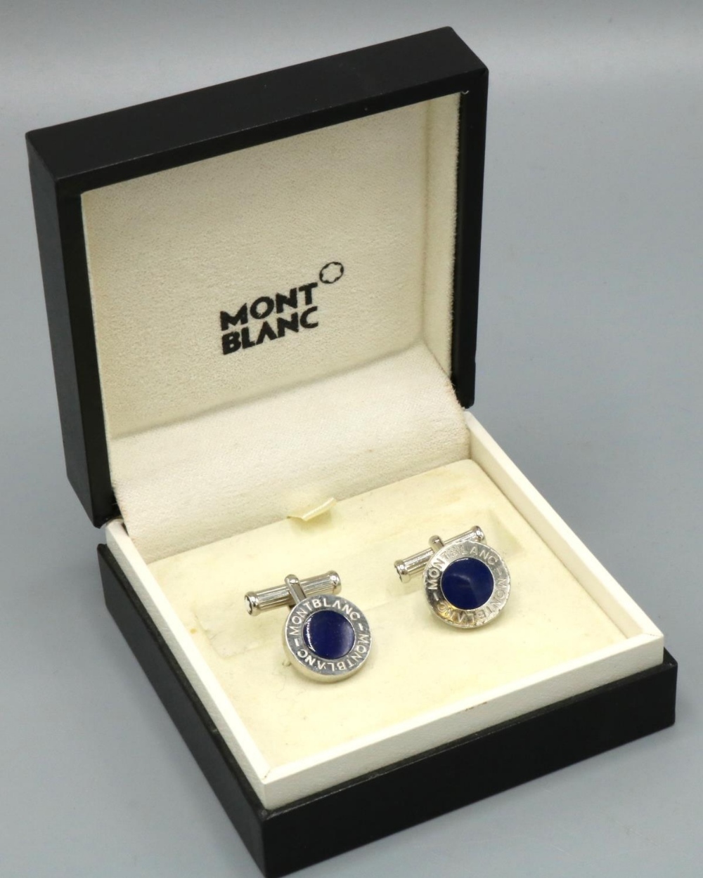 Pair of Montblanc chrome circular cufflinks, with blue inset in Montblanc surround, stamped