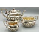 Victorian hallmarked silver three piece tea service, lobed bodies with gadrooned borders and angular