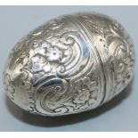 George III unmarked silver egg shaped nutmeg grater, chased and engraved with C scrolls and flowers,