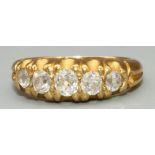 Yellow metal five stone diamond ring, the graduated brilliant cut diamonds in claw settings, on