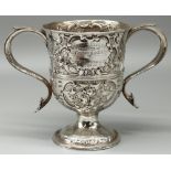 George III hallmarked silver two handled loving cup, body later repousse with scrolls and flowers,
