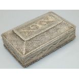 C20th foreign white metal filigree rectangular box, with stepped hinged lid on four ball feet, L12cm