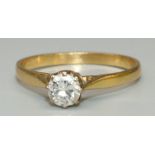 18ct yellow gold diamond solitaire ring, the round cut diamond claw set on on tapered shoulders