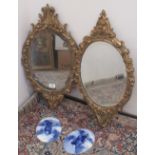 Pair of C20th gilt finish carved oak wall mirrors, oval bevelled plates in C scroll frames, H70cm