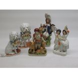 Three Staffordshire style figures and two models of dogs with baskets of pigs (5)