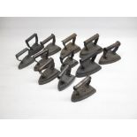 Collection of twelve cast metal flat irons