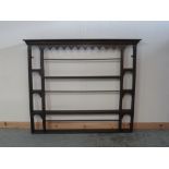 C19th oak three tier plate rack, with dentil cornice and shaped frieze, W48cm H125cm