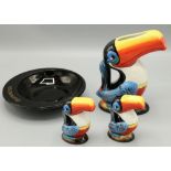 Guinness Toucan jug, H15cm, a pair of similar cruets, H8cm, and a Guinness black glass ashtray,