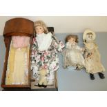 C20th oak dolls rocking crib overall L46cm, and three bisque headed dolls H31.5cm