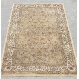 C20th traditional pattern antique gold ground rug with central floral pattern field and stylised