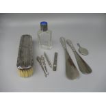 Glass dressing table bottle with hallmarked silver and blue enamel lid, a dressing table brush