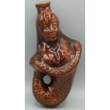 C19th Staffordshire brown glazed pottery flask, modelled as fish tailed Victoria, H20cm