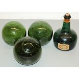 Three green glass fishing floats and a musical green glass liqueur bottle (4)