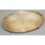 George V hallmarked silver oval salver with pierced border on four scroll feet, by Adie Brothers Ltd